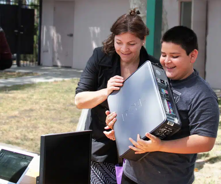 A mother and son recycling old it support in los angeles.