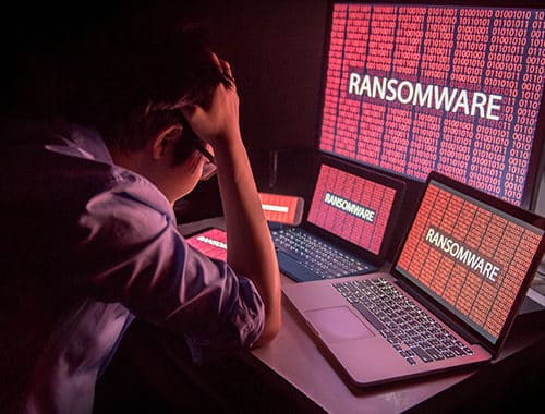 A young Asian business owner is stressed and fears for the continuity of his business after a ransomware attack encrypts all his files.