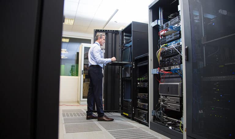 An IT manager technician testing a restore point on a business backup and disaster recovery appliance for a managed IT services client.