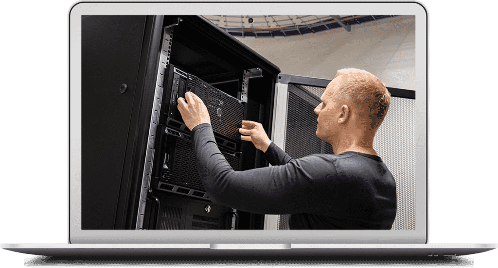 An IT engineer installs a new Dell business server within a server room.