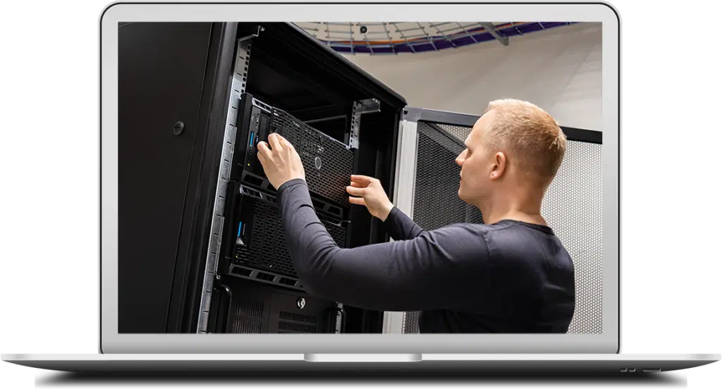An IT engineer installs a new Dell business server within a server room.