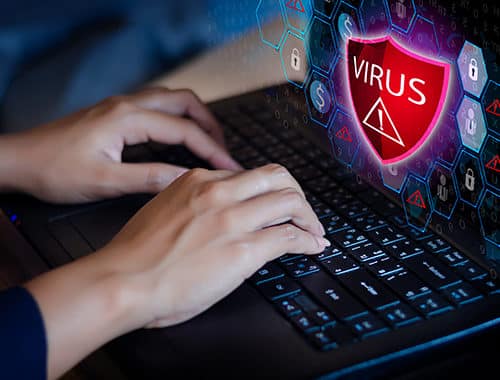 Concept illustration of a woman typing on her laptop keyboard with a virus warning sign on a red shield and security icons extending from her screen.