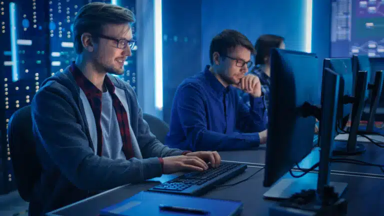 Two IT experts working help desk services.