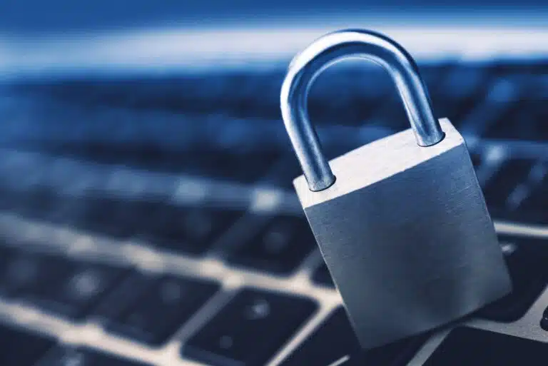 A padlock on a computer keyboard, demonstrating cybersecurity - one of the top benefits of single sign on (SSO)